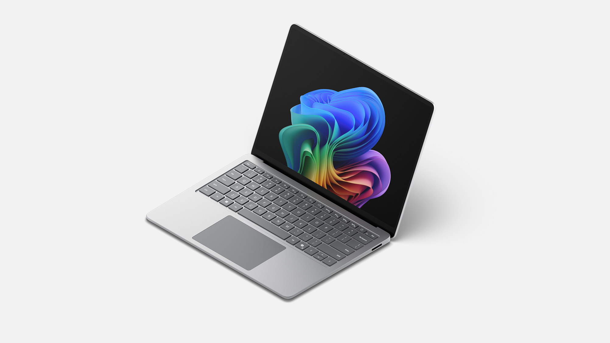 A Surface Laptop for Business, 13.8 and 15-inch | Intel facing left displaying the rainbow bloom image.