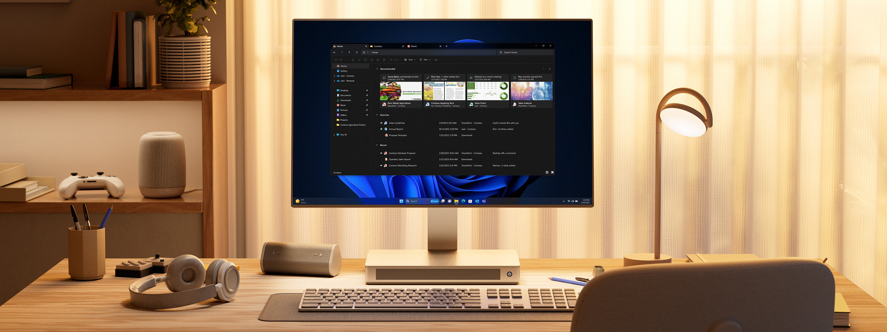 Home office with desk, keyboard and all-in-one desktop displaying File Explorer window.