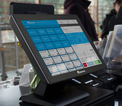 Point-of-sale touchscreen system displaying a colorful interface with product buttons, used in a retail setting.