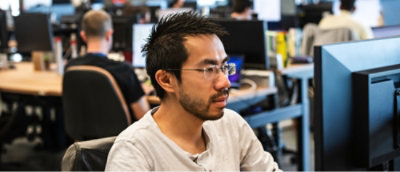 Office environment with employees working at computer stations.