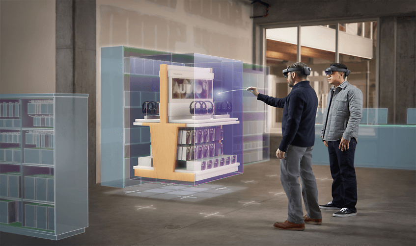 Dua orang mengenakan headset HoloLens sedang melihat perenderan 3D penyiapan sebuah toko.