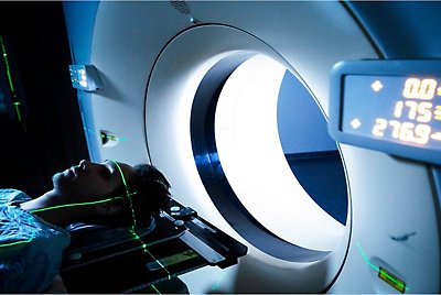 A person laying down and being slid into an MRI machine 