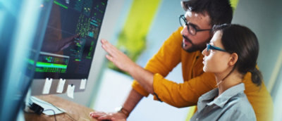 Two person's looking at a computer screen