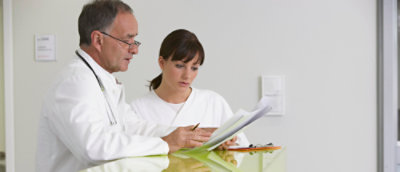 A doctor and nurse looking at a document.