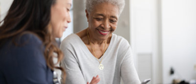 A woman smiling at another woman.