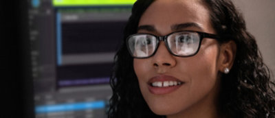 A person with glasses and curly hair.