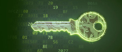A key with a glowing green light on a green circuit board with various text and numbers.