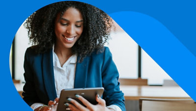 A person looking down and smiling at a tablet