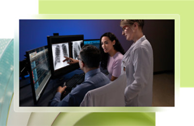 A group of people looking at a computer screen.