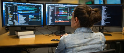 A woman looking at a computer screen.