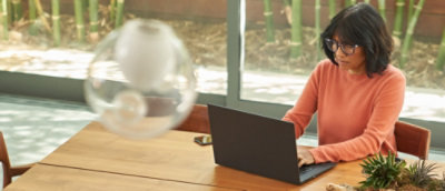 A woman sitting at a table using a laptop