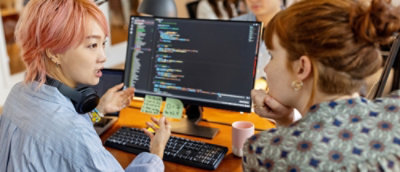 A group of people looking at a computer screen.