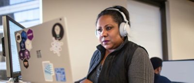A man in a suit is talking to a man in a gray shirt.
