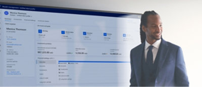 A man stands in front of a large screen displaying a website.