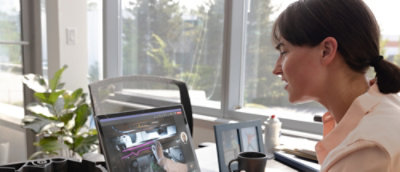 A woman looking at a computer screen.
