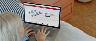 A woman's hands typing on a laptop keyboard.