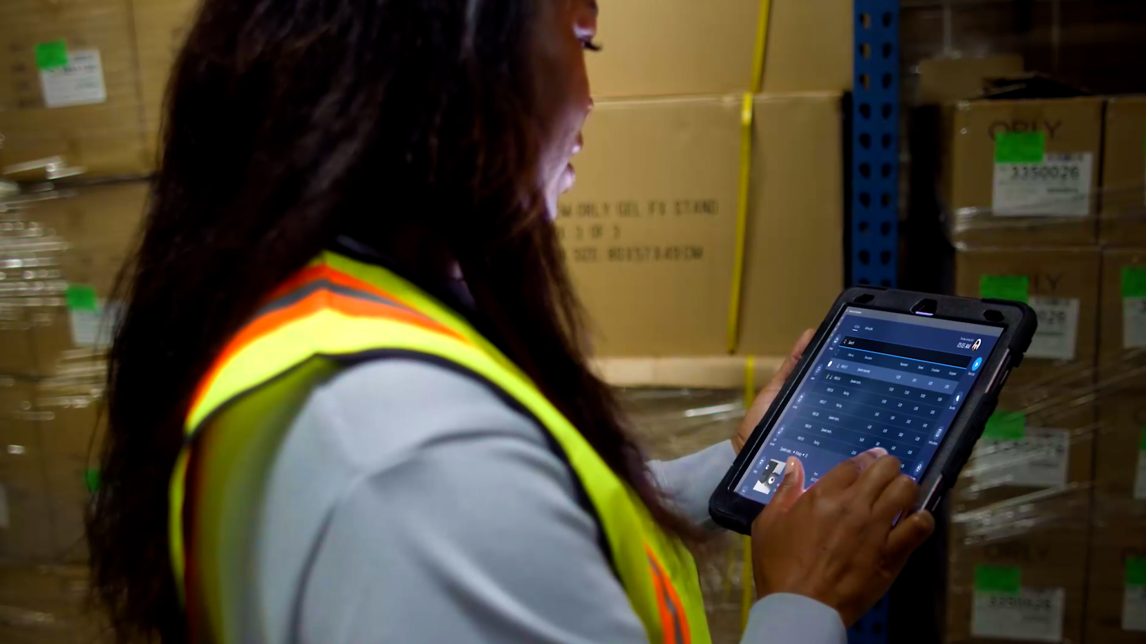 A person working on a tablet in a warehouse