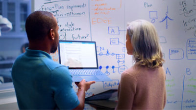 A person speaking while working on a computer