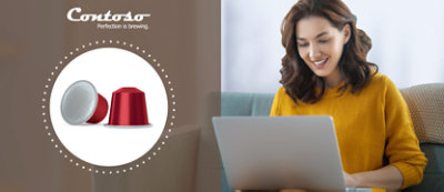 A woman sitting on a couch using a laptop.