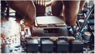 A hand placing a chip inside a machine