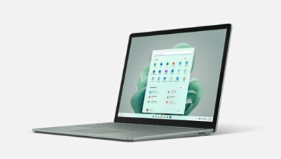 Front view of Surface Laptop 5 in platinum with a green blossom on the Windows 11 start screen.