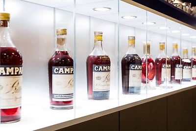 Campari liquor bottles on an illuminated shelf