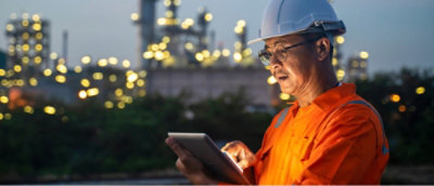 A man wearing helmet, checking something in tablet