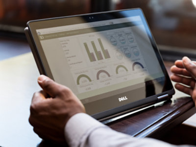 A person holding tablet in his hand and looking dashboard screen