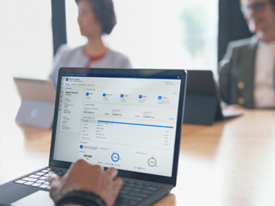 A person is using a laptop in a meeting