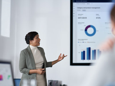 A person giving a presentation in a big screen