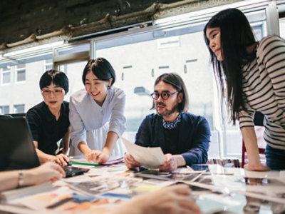 A group of people sitting around a table in an office.