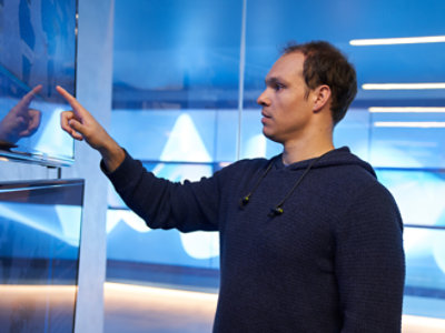 A person using a touch screen monitor