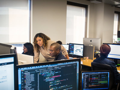 Group of people sitting in the office and working with their system