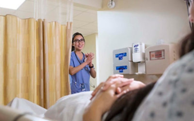 A medical professional walking into a patient’s room in a hospital
