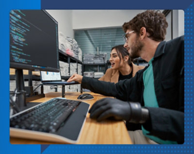 A person working ona screen with another person
