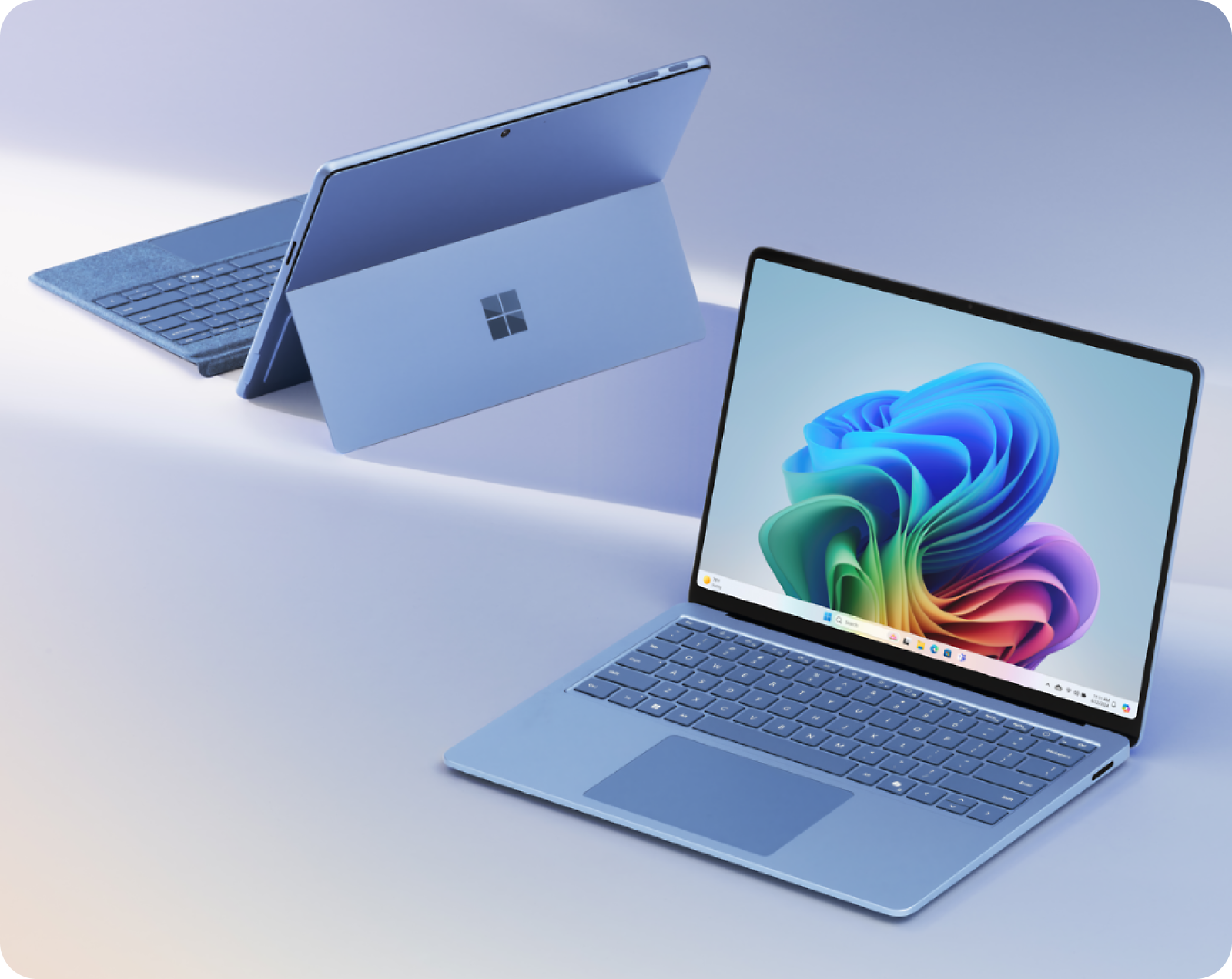 Two Microsoft Surface devices: one in laptop mode displaying Windows wallpaper and one in tablet mode with a kickstand
