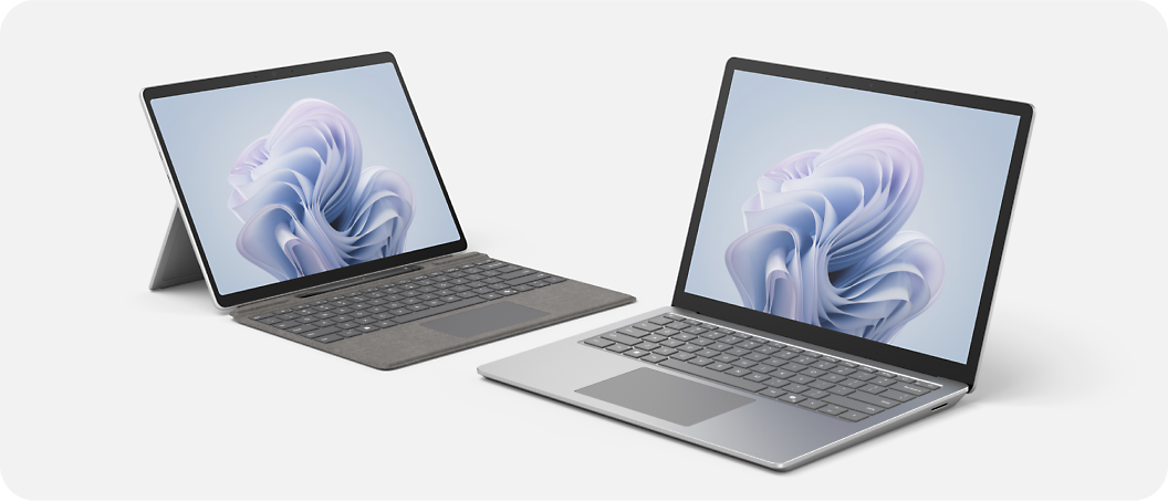 Two laptops are displayed, one with a detachable keyboard and kickstand, and the other with a built-in keyboard