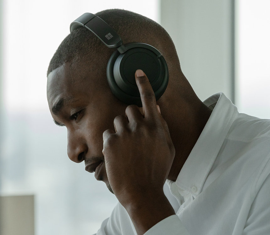 A person wears Surface Headphones.