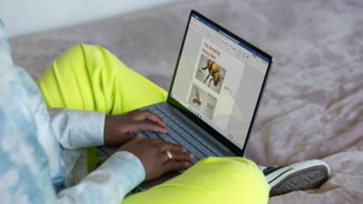 A person uses Surface Laptop Go to edit documents.