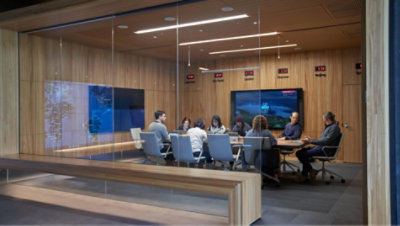 People having a meeting in a glass conference room 