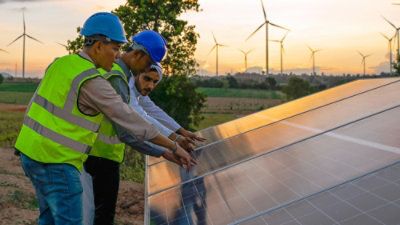 A group of men wearing safety vests and helmets