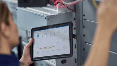 A person holding a tablet displaying data