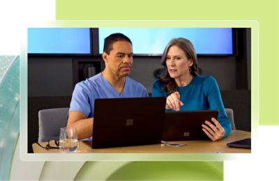 A man and woman looking at laptops.