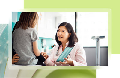 A doctor talking to a young girl.