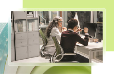 A man and woman sitting at a desk.