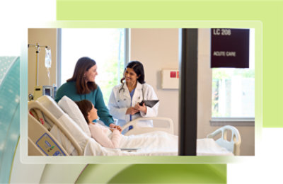 A doctor and a child patient in a hospital bed.