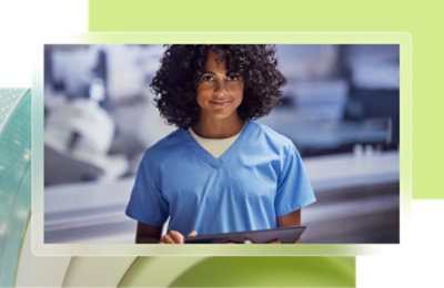A woman in a white coat looking at a computer screen and talking into a microphone.