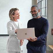 Two person discussing and person in the right is holding laptop