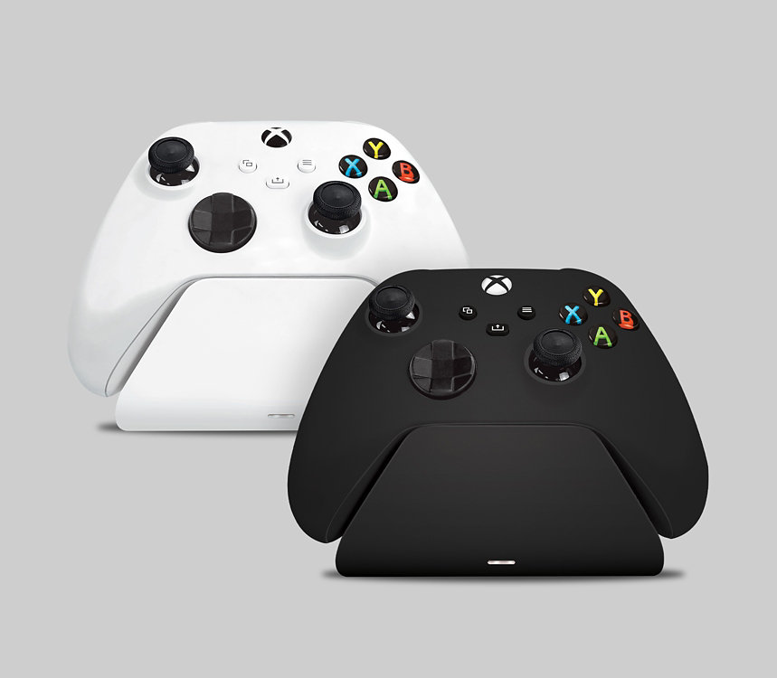 Xbox wireless controllers in charging stands.