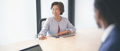 テーブルに向かって座っている女性。